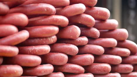 close up of a stack of red sausages