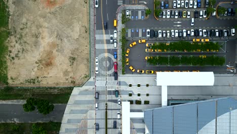 bustling roads and parking lot of chiayi hsr (high speed rail) train station, taibao city, taiwan - aerial top-down view