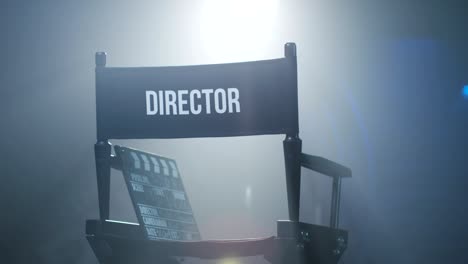 chair of director with clapboard in spotlight