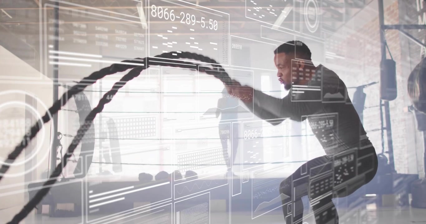 Bending into squat, male athlete generating battle rope waves in fitness studio, analytics tracking