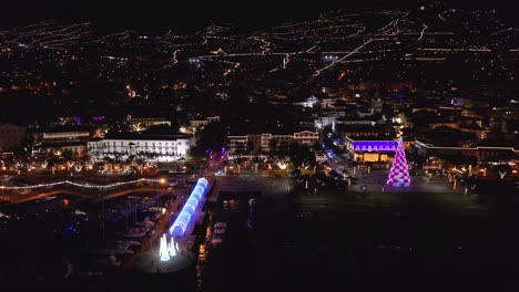 night time at funchal city on madeira island during christmas holiday with light decoration, aerial