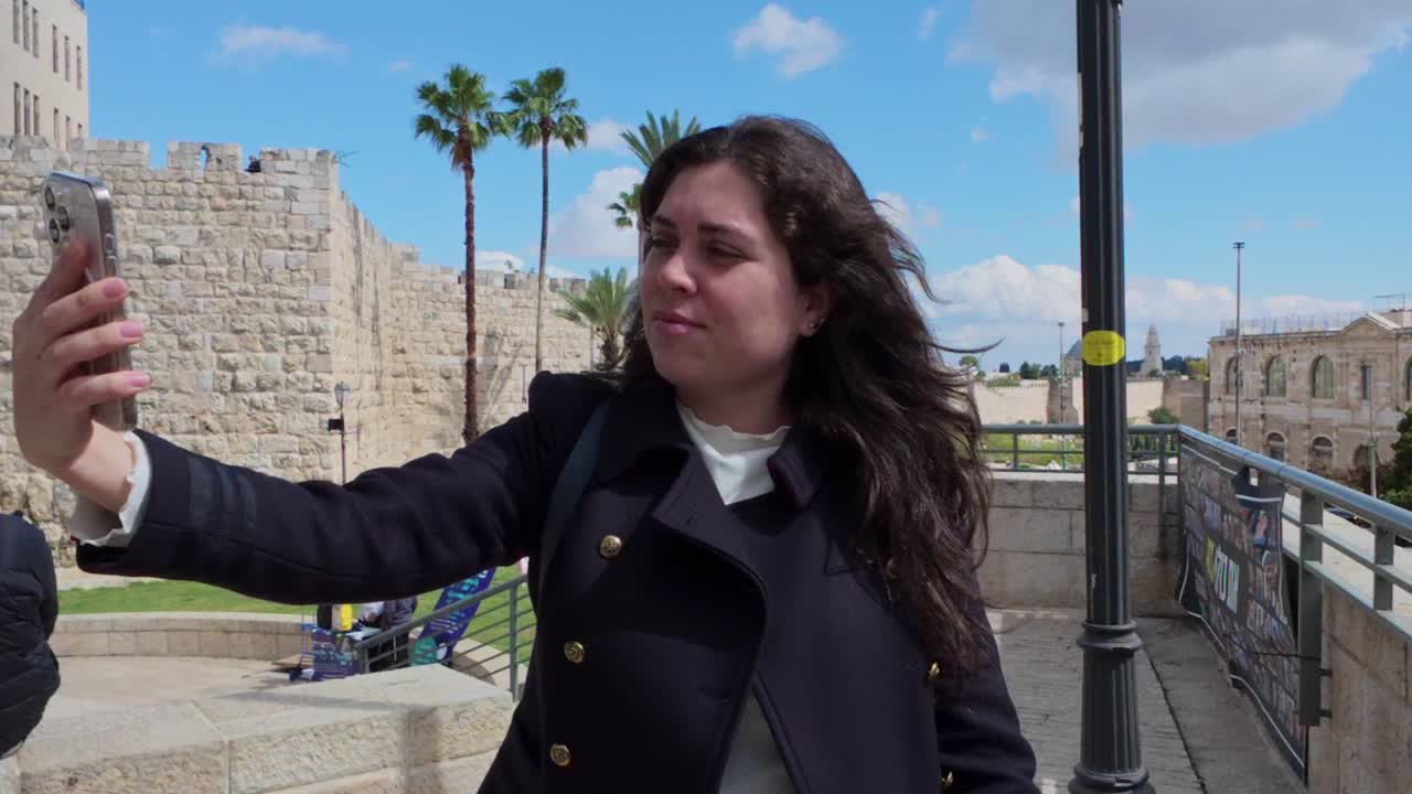 Young woman taking selfies in Jerusalem old city