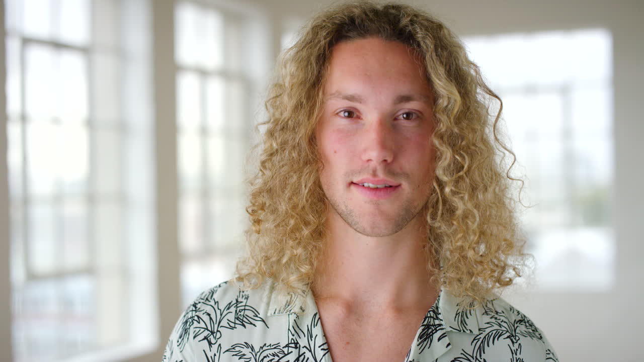 retrato de un hombre rubio sonriendo en el interior