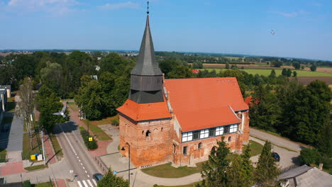 Drone-shot-of-beautiful-medieval-church-in-Cedry-Wielkie,-Poland