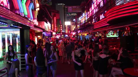 crowded street scene with neon lights at night