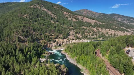 Panoramic-Aerial-Of-The-Kootenay-River-With-Dense-Forest-Mountains-In-Northern-Montana