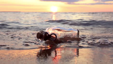 message in the bottle against the sun setting down