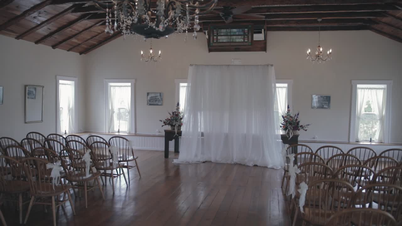 Slow dolly shot of an empty vintage rustic wedding ceremony venue after setup