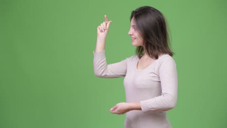 young happy beautiful woman showing something