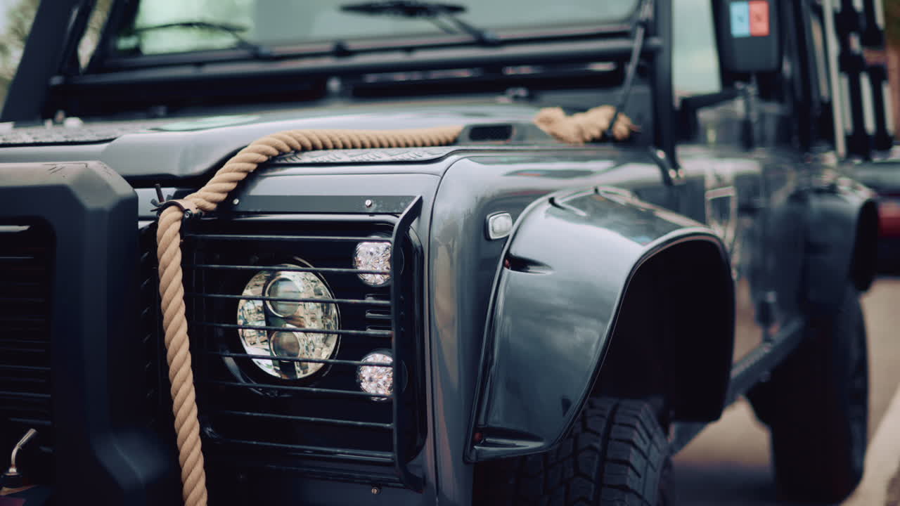 Close up of a rugged off road vehicle with a thick rope across its hood