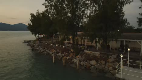 drone shot of a row of seafront homestay at evening, marina island, malaysia