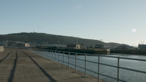 4k swansea bay uk panning shot of west pier towards marina dockyards wales uk