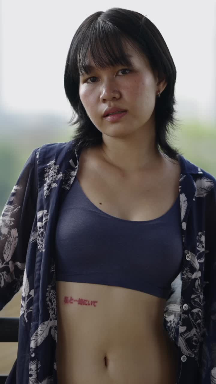 Portrait of woman in blouse with tattoo