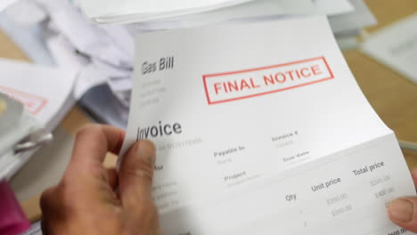 close up of a man opening energy debt letters