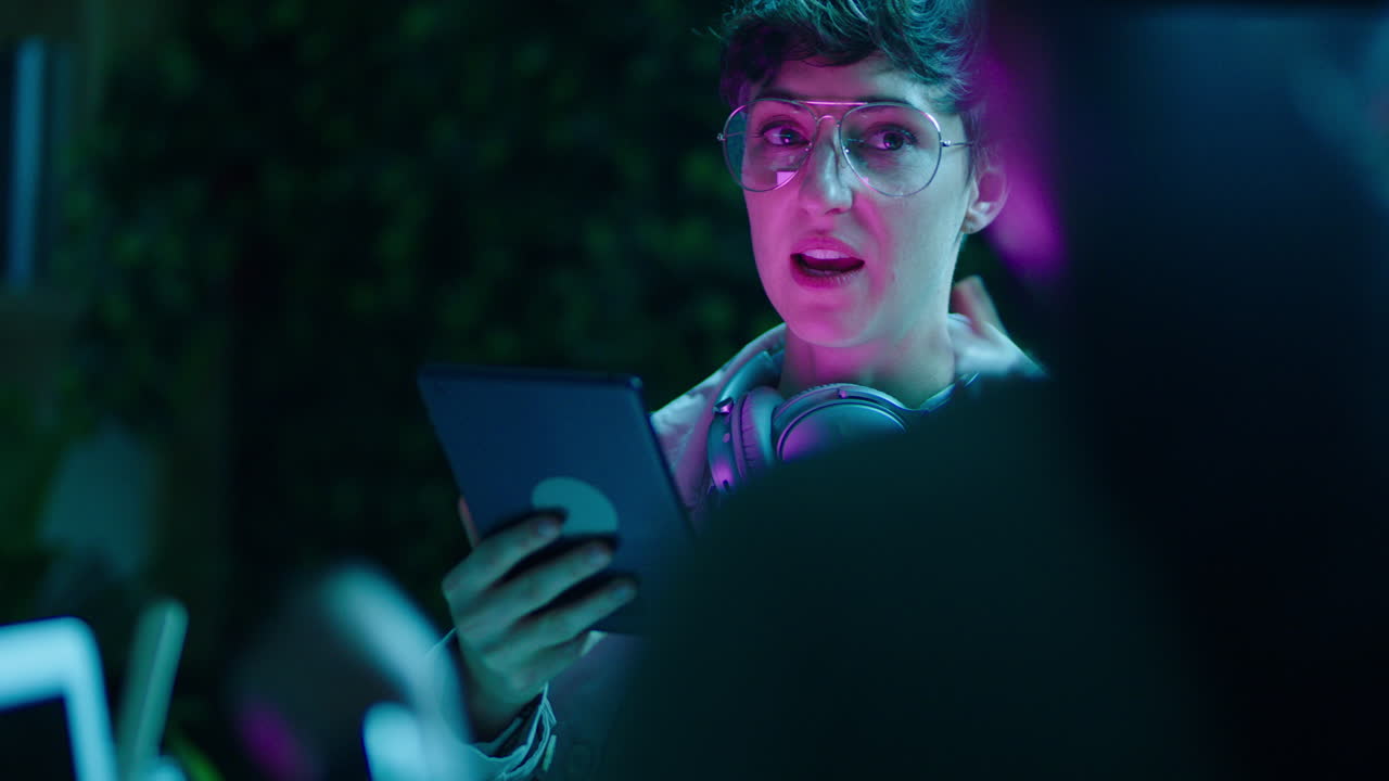 caucasian business woman working late colleagues using tablet computer technology brainstorming ideas for project discussing deadline manager woman sharing strategy meeting in office at night