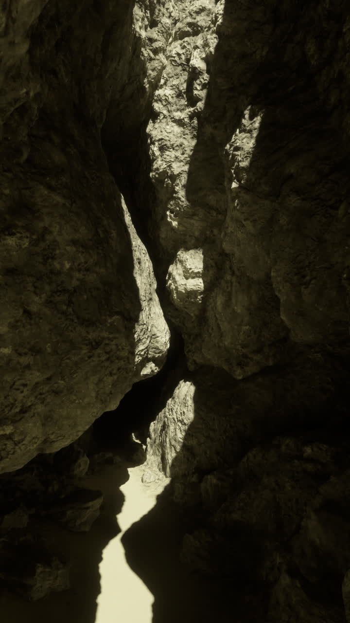 Exploring a narrow rock canyon illuminated by sunlight in the afternoon