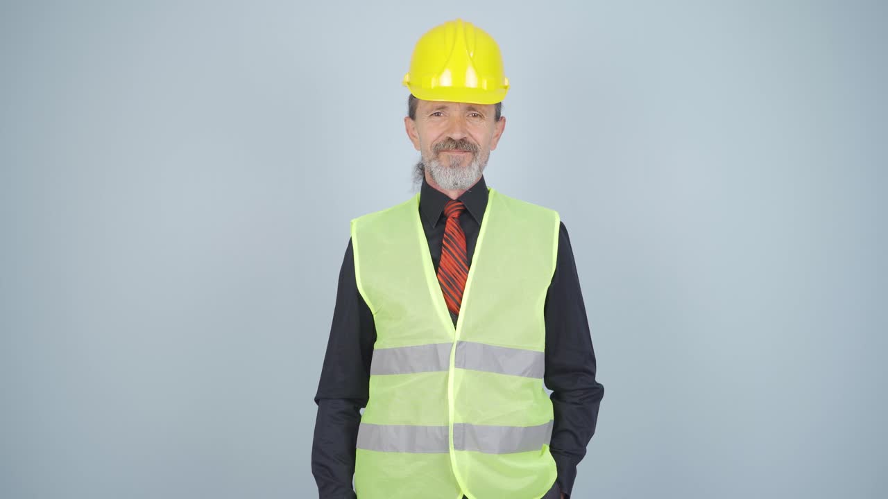 el ingeniero con un casco y sonriendo.