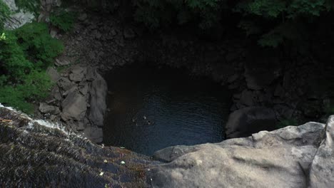 aerial view of young woman walking by creek, top of ozone falls, tennessee usa