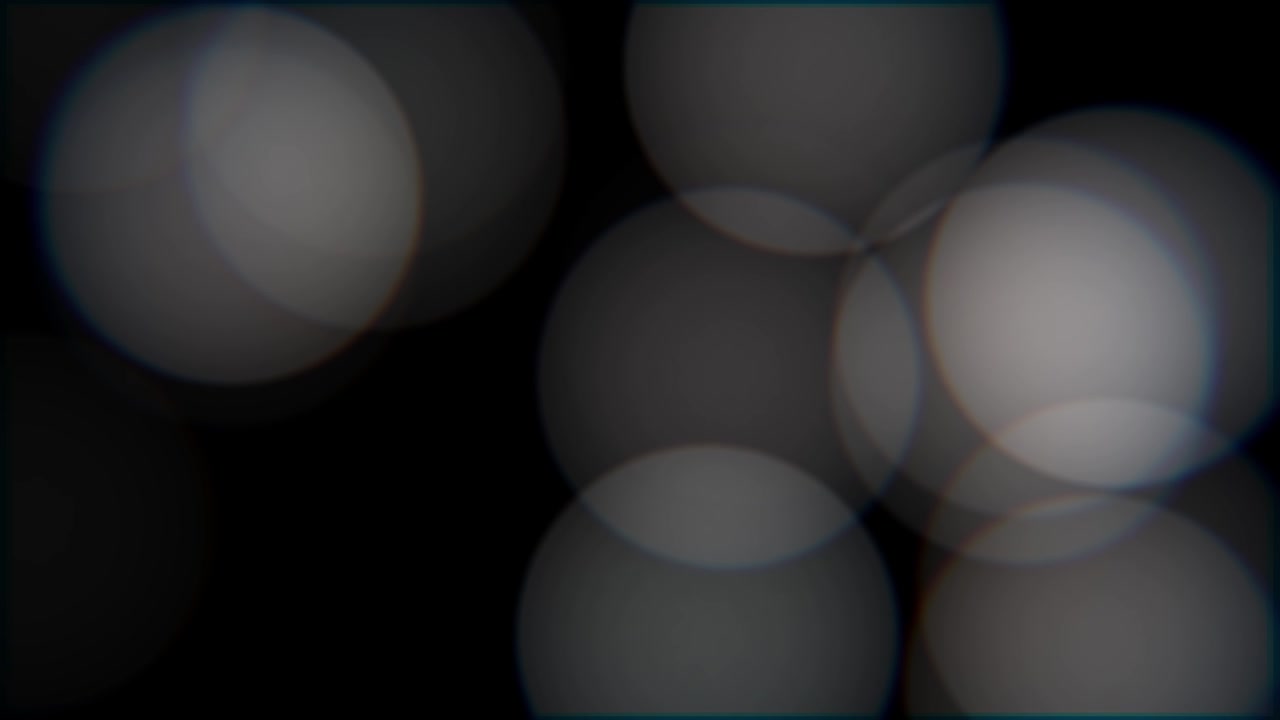 Abstrakter Hintergrund: Weiche weiße Bokeh-Kreise auf Schwarz