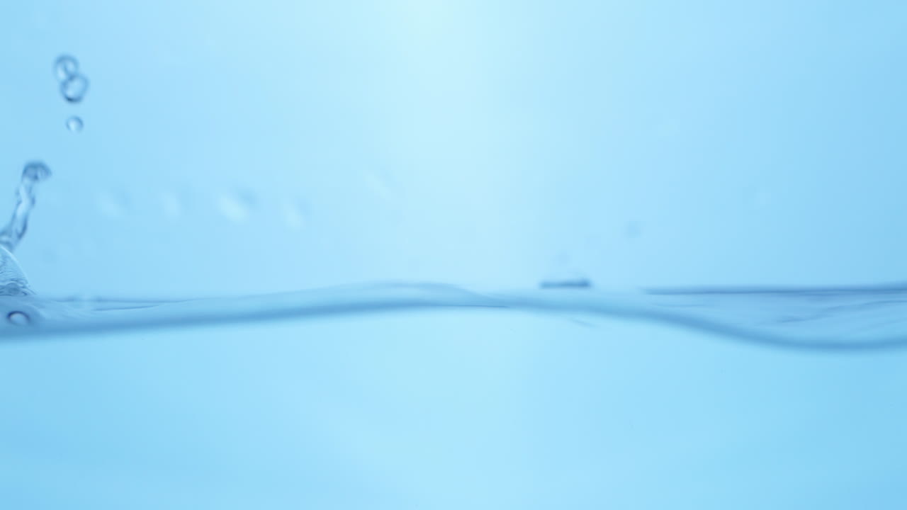 Dramatic close-up of water in slow motion, highlighting the purity and freshness of blue waves, perfect for any content related to clean drinking water.