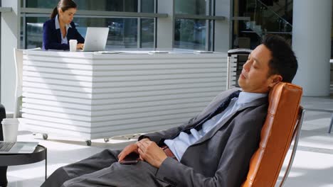 businessman relaxing on sofa in reception 4k