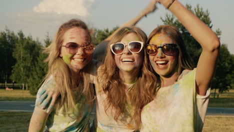 happy friends taking selfie at holi festival