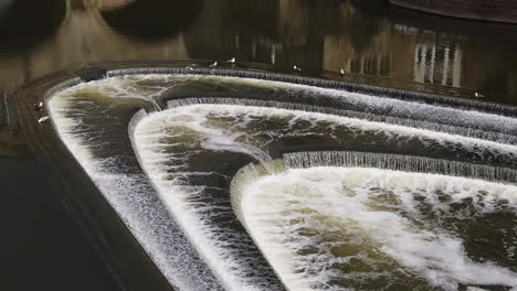 Super-Slow-Motion-Close-Up-of-Seagulls-taking-off-from-Pulteney-Weir-on-Summer’s-Day-in-Bath,-Somerset