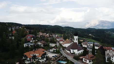 drone shot of oberbozen and the surrounding lush countryside of italy