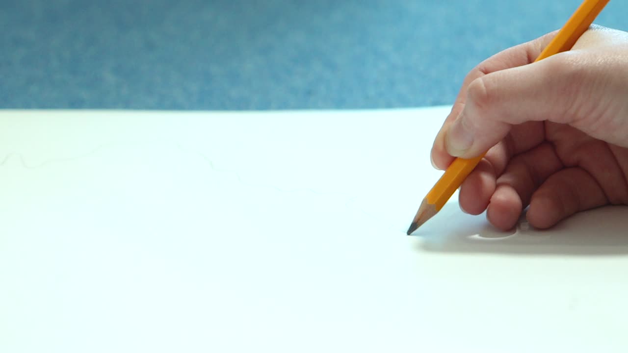 Female hand drawing with a pencil in sketchbook. Young woman learns to draw.