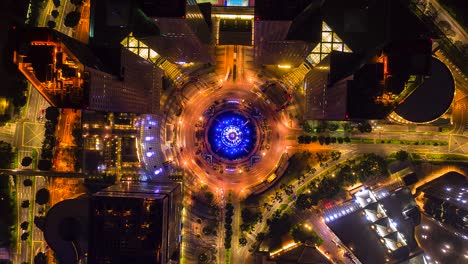 aerial view time lapse of the fountain and traffic in the circle at night at singapore