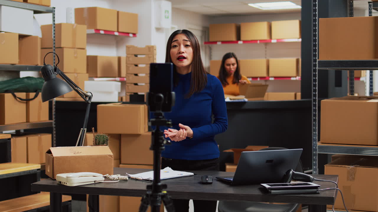 An Asian woman is making a video in a warehouse