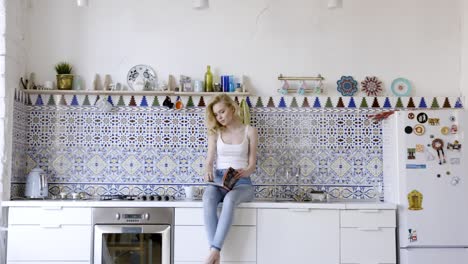 mujer leyendo en una cocina moderna