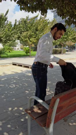 businessman preparing to sit on park bench