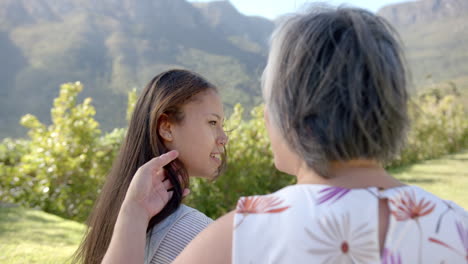 Enjoying outdoor time together in nature, asian grandmother and granddaughter smiling