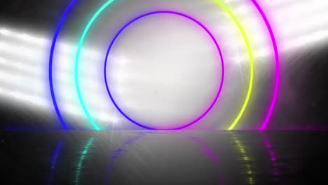 3d-animation-of-colorful-circular-neon-beams-zooming-against-glowing-flood-light-at-stadium