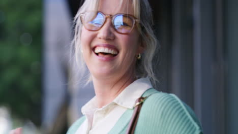 a woman smiling and laughing outdoors