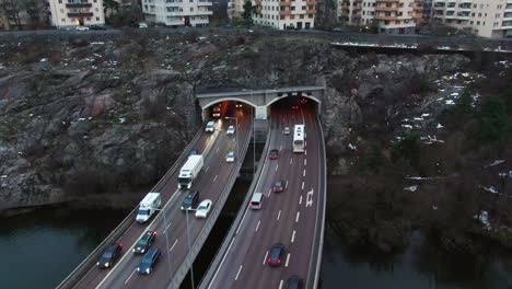 parallaxing drone shot over stockholm freeway tilt up towards skyline