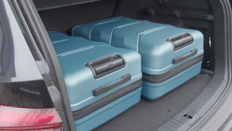 travel and camping luggage packed in the car trunk