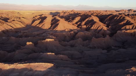 Golden-hour-flyover-of-eroded-red-hills-landscape-in-Chile-altiplano