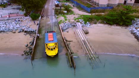 aerial shot showing amphibious vehicle driving into water from street,malaysia