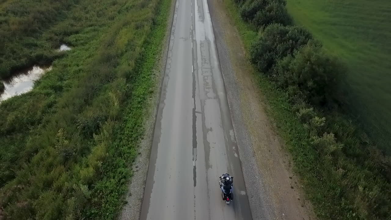 Aerial view of motorcycle riding on a rural road