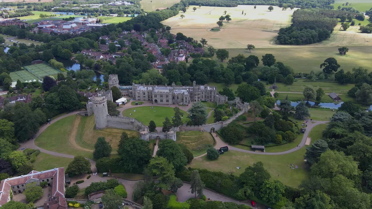Aerial Front View Of Warwick Castle In Distance And Neighborhoods In Background At Warwick, United Kingdom