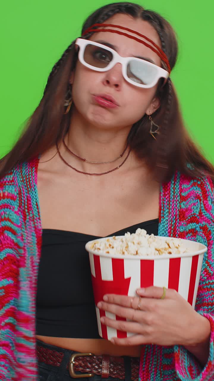Woman in 3d glasses eating popcorn and watching interesting tv serial sport game film online movie