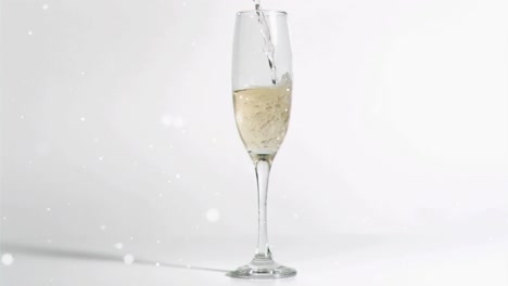 Animation-of-white-specks-falling-over-glass-of-champagne-on-white-background