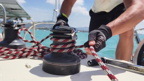 sailor working on sailboat winch