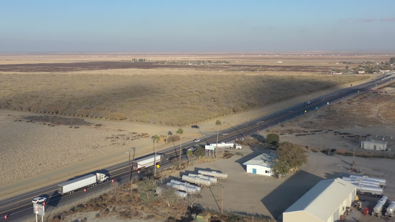 Trucks driving on California Highway through drought-stricken area
