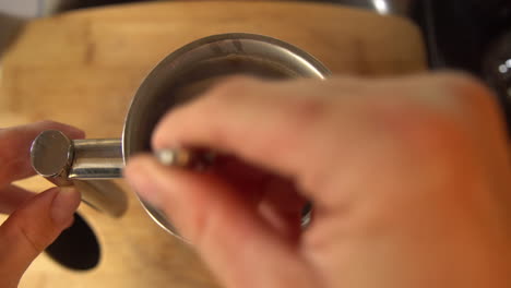 Top-down-shot-of-a-man-mixing-the-coffee-grounds-in-a-french-press