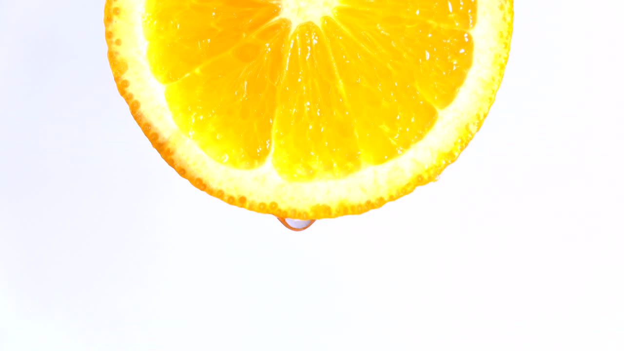 Water or oils dropping on an orange slice , fruit for diet and healthy food