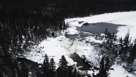 A-Slow-4K-Drone-Shot-of-environment-nature-Tourism-Travel-Landmark-frozen-winter-Pisew-Kwasitchewan-Falls-Waterfall-Provincial-Park-near-Thompson-Manitoba-Northern-Arctic-Canada-Landscape