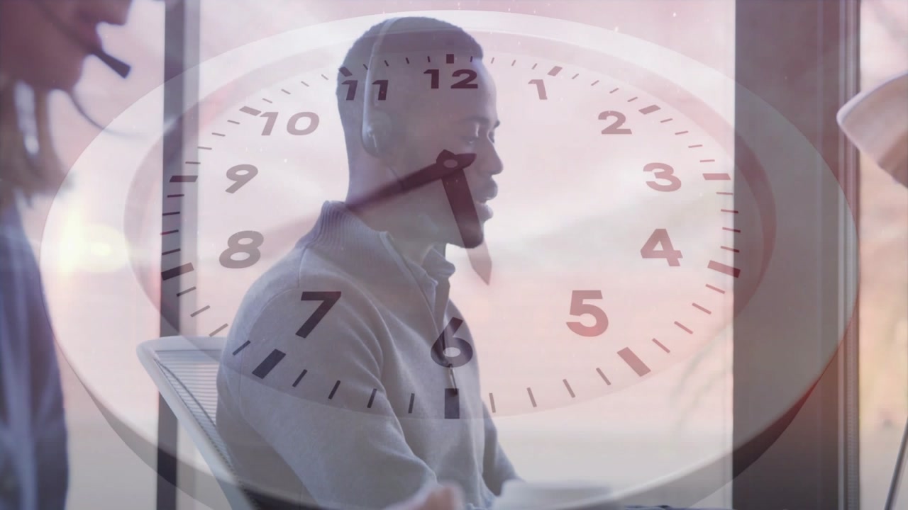 Speaking headset-clad man in light shirt answering call at office, clock overlay tracking time